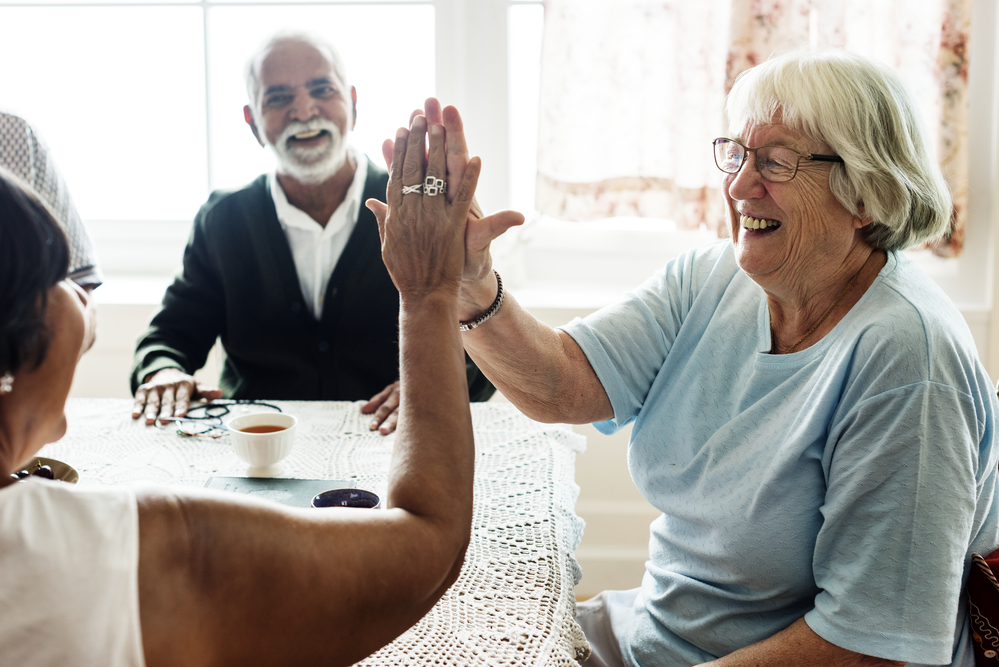 Discussing Nursing Home Abuse With Family - Senior women giving each other high five